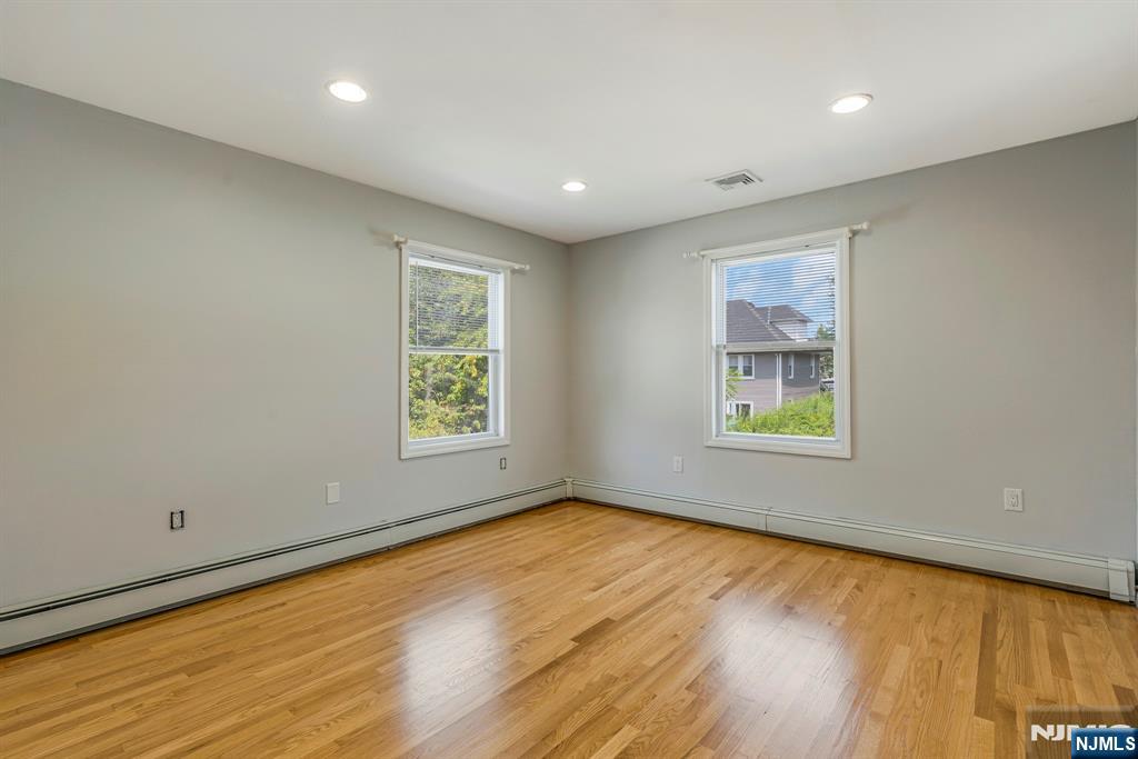 24 Sunderland Avenue Rutherford, NJ 07070 - Photo 39 of 40 wooden floor in an empty room with a window