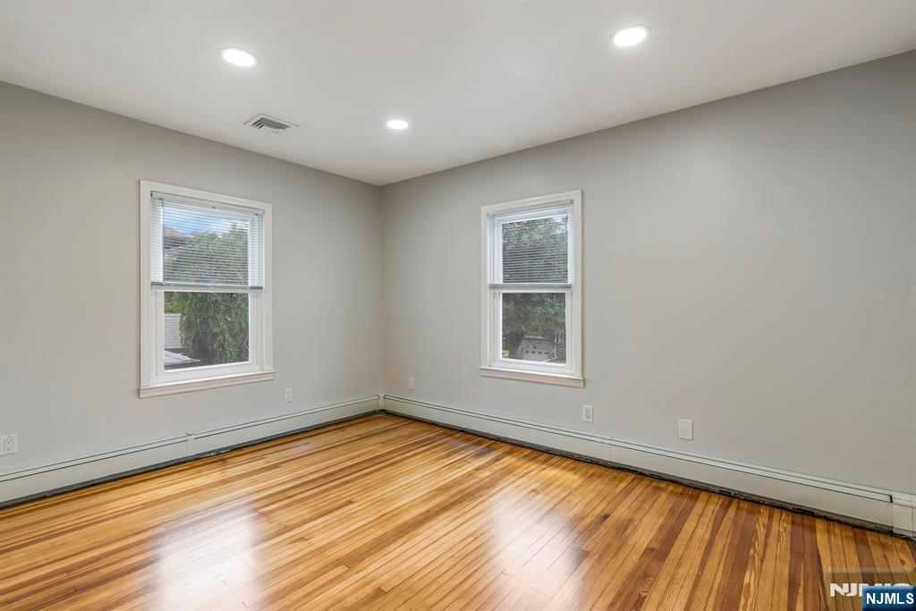 24 Sunderland Avenue Rutherford, NJ 07070 - Photo 40 of 40 an empty room with wooden floor and windows