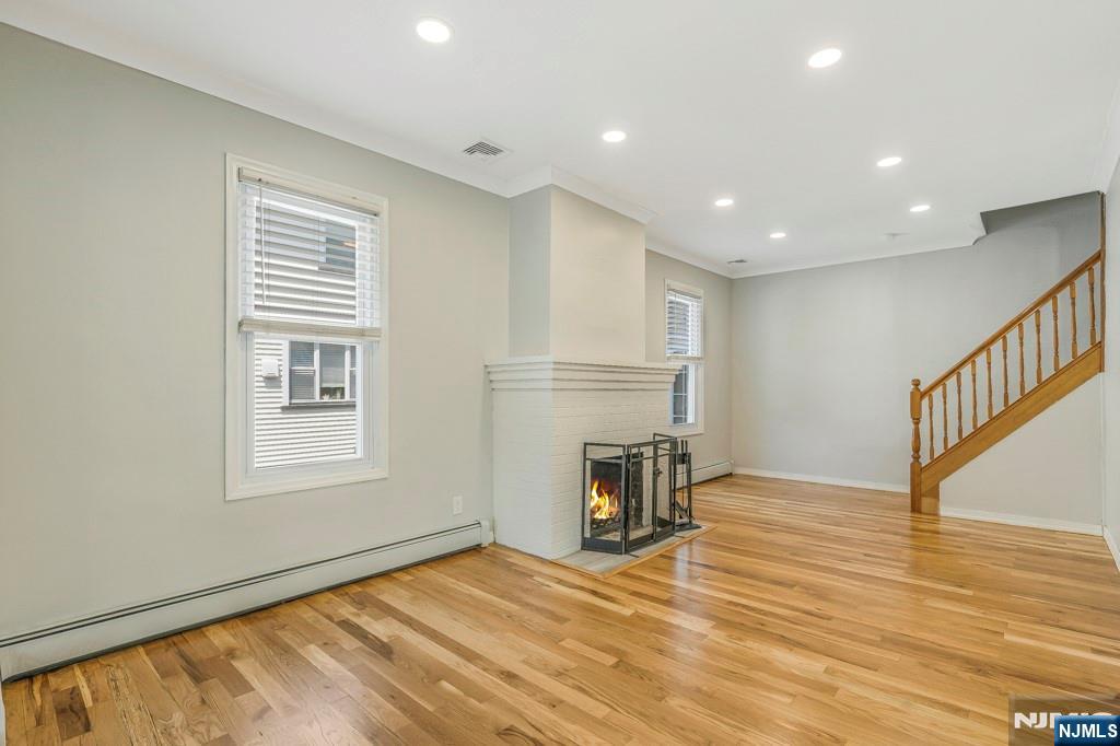 24 Sunderland Avenue Rutherford, NJ 07070 - Photo 7 of 40 a view of empty room with wooden floor and fan