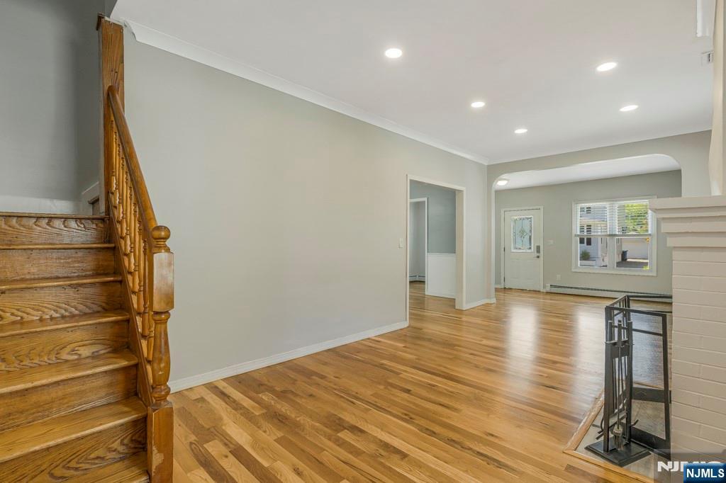 24 Sunderland Avenue Rutherford, NJ 07070 - Photo 9 of 40 a view of empty room with wooden floor and fan