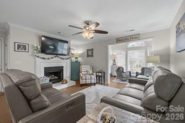 a living room with furniture a flat screen tv and a fireplace