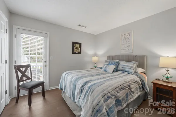 a bedroom with a bed and a lounge chair