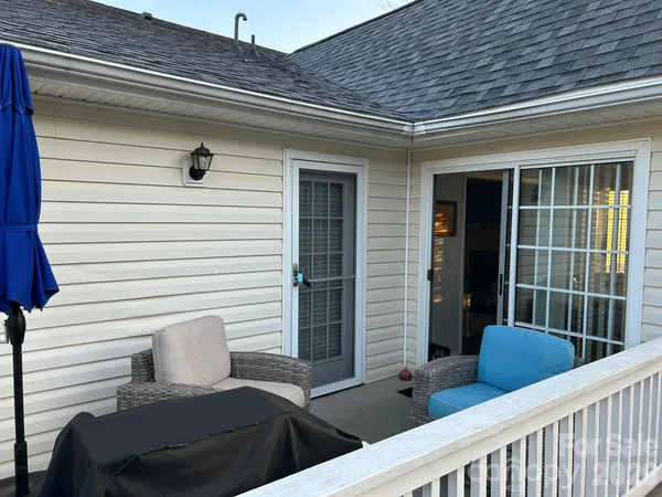 a view of a chair and tables in the balcony