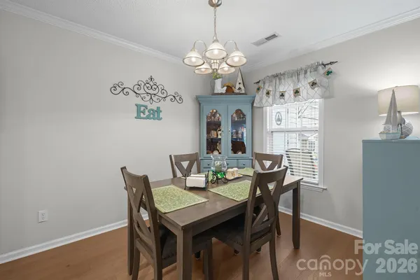 a view of a dining room with furniture and chandelier