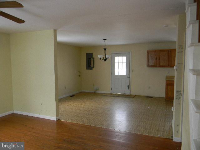 3922 North Point Road Baltimore, MD 21222 - Photo 3 of 22 an empty room with wooden floor and windows