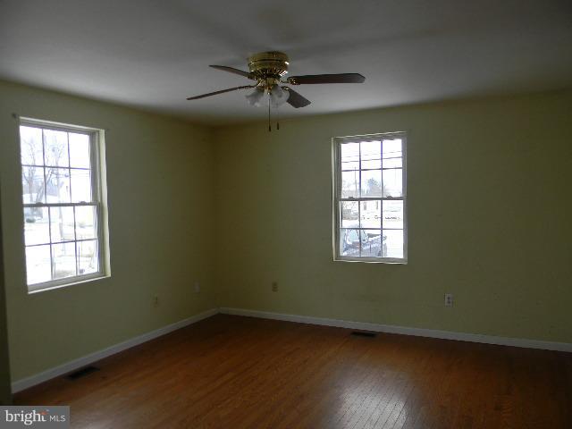3922 North Point Road Baltimore, MD 21222 - Photo 6 of 22 a view of an empty room with wooden floor and a window