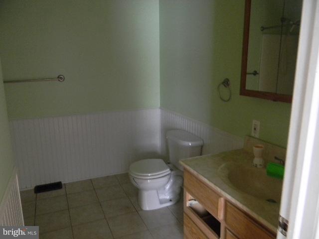 3922 North Point Road Baltimore, MD 21222 - Photo 7 of 22 a bathroom with a granite countertop toilet and a sink