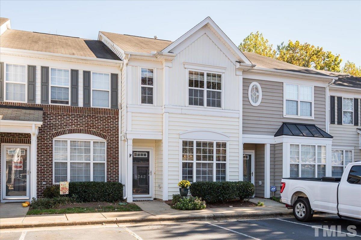 8342 City Loft Court Raleigh, NC 27613 - Photo 1 of 23 a front view of a building with parking space and parking
