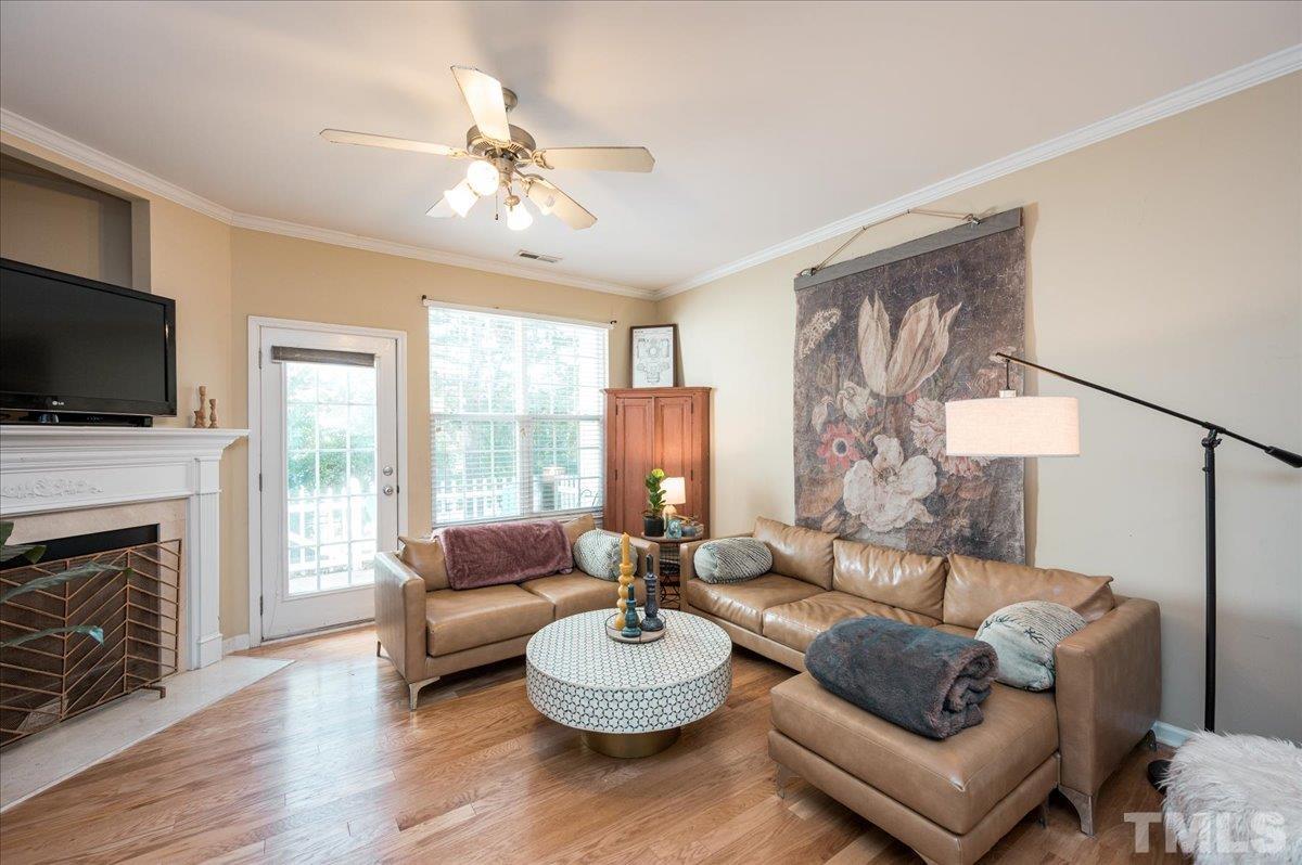 8342 City Loft Court Raleigh, NC 27613 - Photo 12 of 23 a living room with furniture a fireplace and a flat screen tv