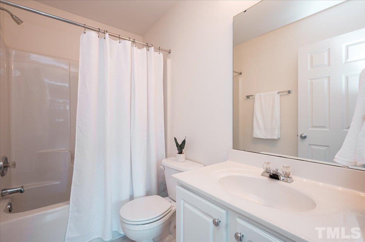8342 City Loft Court Raleigh, NC 27613 - Photo 18 of 23 a bathroom with a sink toilet and shower
