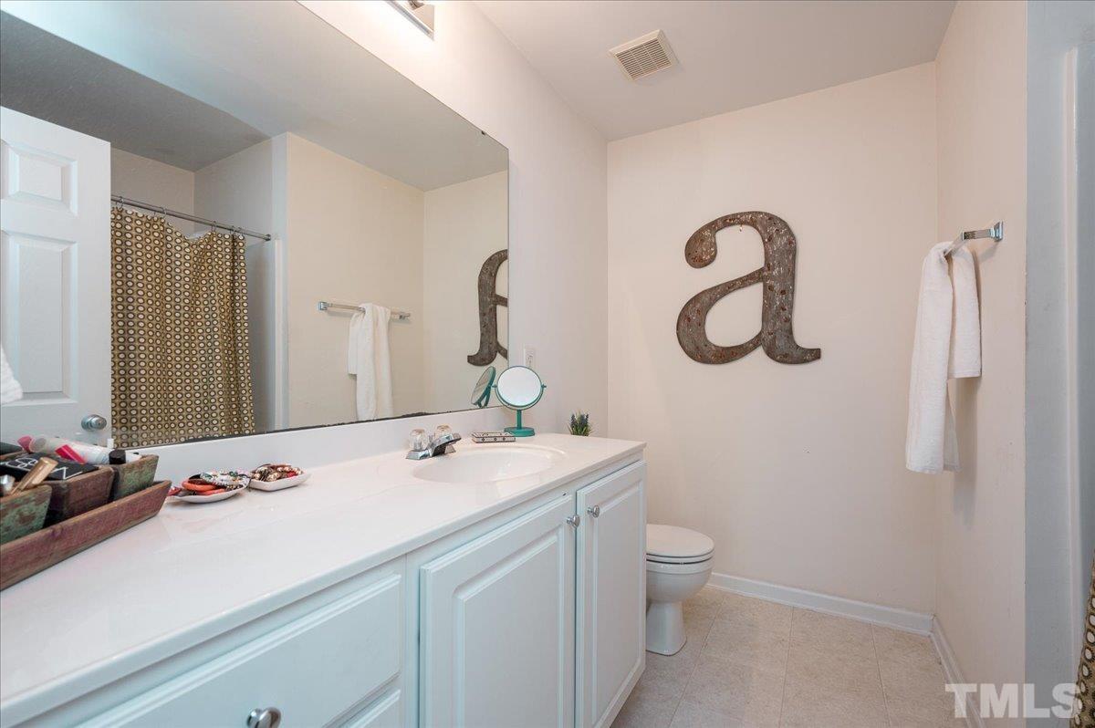 8342 City Loft Court Raleigh, NC 27613 - Photo 21 of 23 a bathroom with a sink toilet and shower