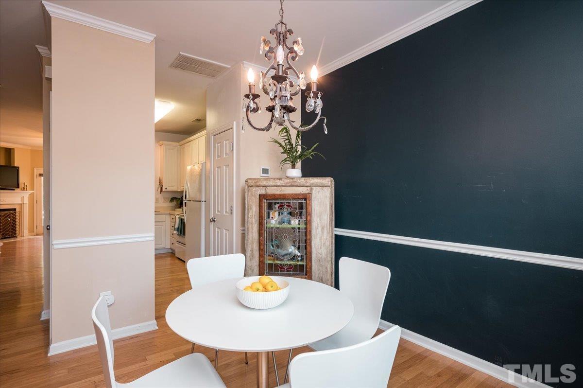 8342 City Loft Court Raleigh, NC 27613 - Photo 6 of 23 a view of a dining room with furniture and wooden floor