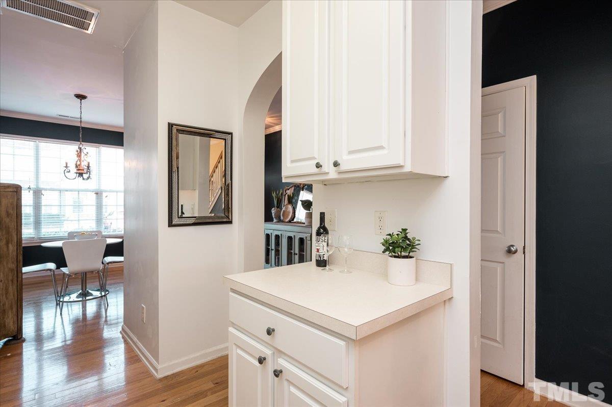 8342 City Loft Court Raleigh, NC 27613 - Photo 9 of 23 a kitchen with a sink cabinets and wooden floor