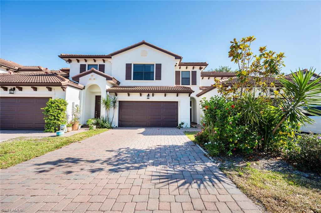 a front view of a house with a yard and a garage