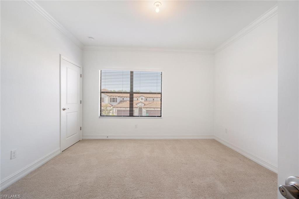 7761 Bristol Circle Naples, FL 34120 - Photo 19 of 32 an empty room with a window