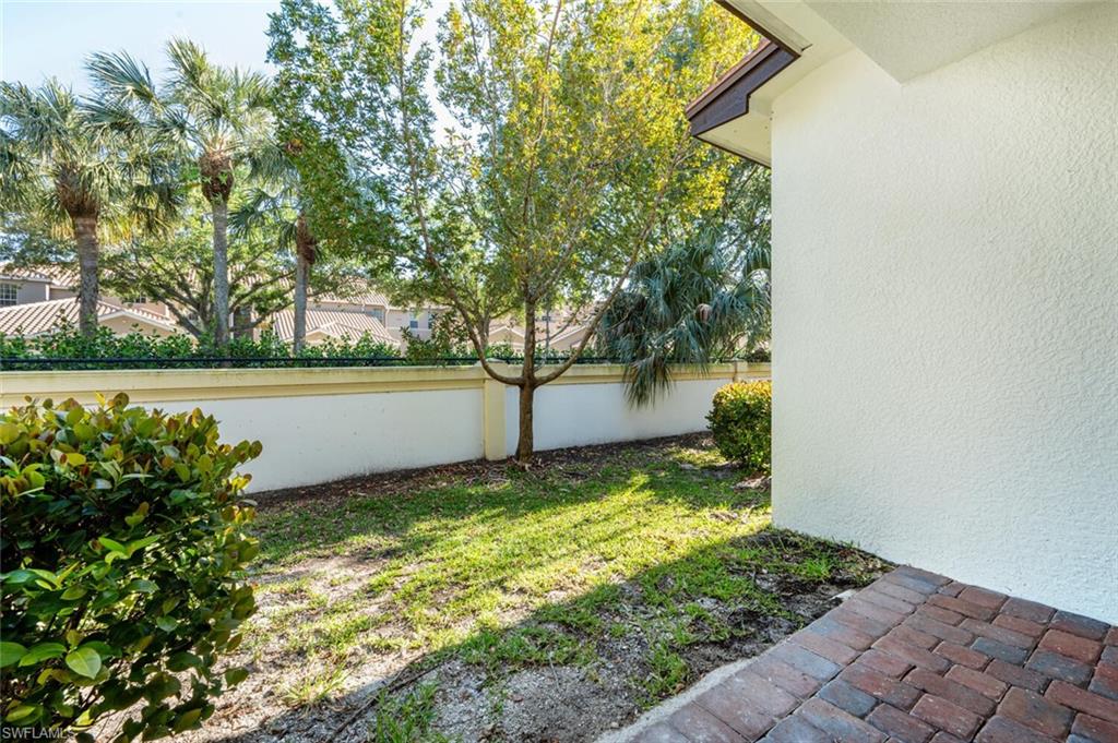 7761 Bristol Circle Naples, FL 34120 - Photo 21 of 32 a view of a garden with a chair