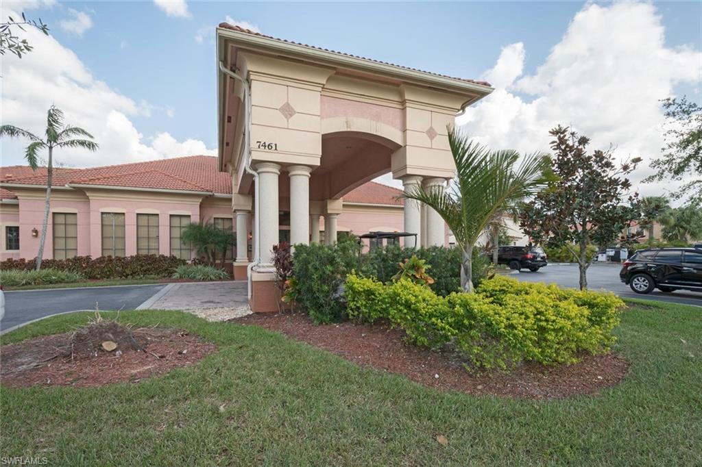 7761 Bristol Circle Naples, FL 34120 - Photo 24 of 32 a front view of a house with garden