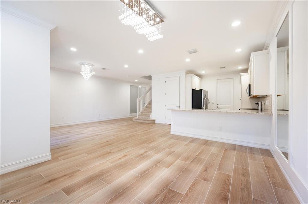 7761 Bristol Circle Naples, FL 34120 - Photo 6 of 32 a view of an empty room and kitchen view
