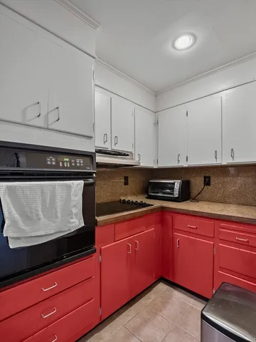 a kitchen with granite countertop cabinets stainless steel appliances and sink
