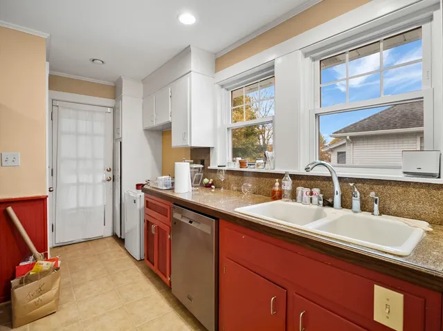 a kitchen with a sink stove and cabinets