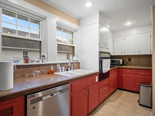 a kitchen with stainless steel appliances granite countertop a sink and cabinets