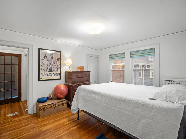 a bedroom with a bed a table and chair