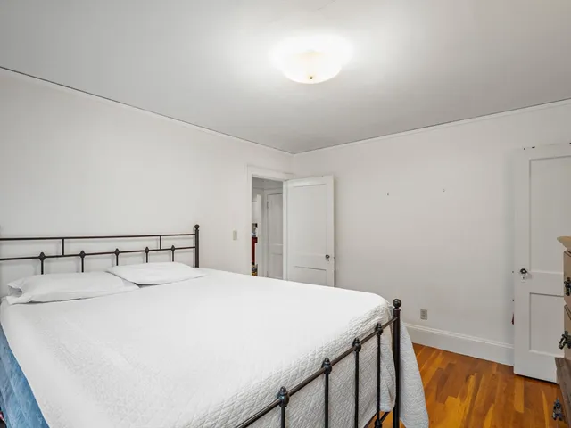 a bedroom with a bed and a table