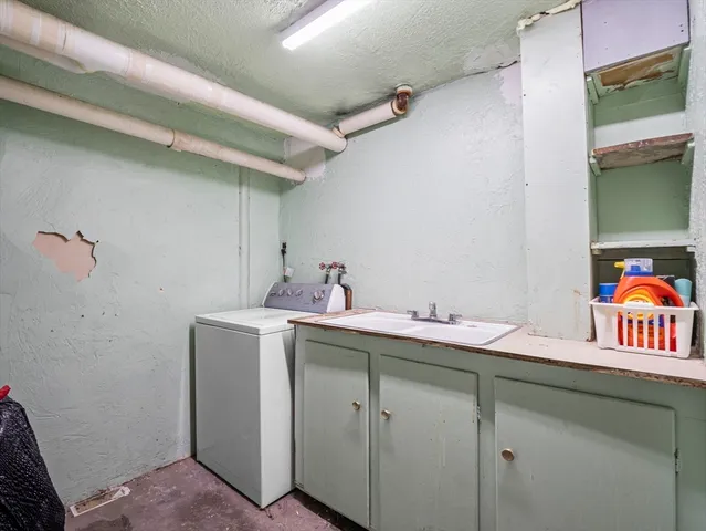 a utility room with a sink dryer and washer