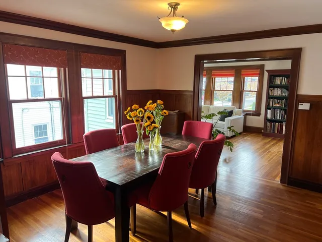 a view of a dining room with furniture window and wooden floor