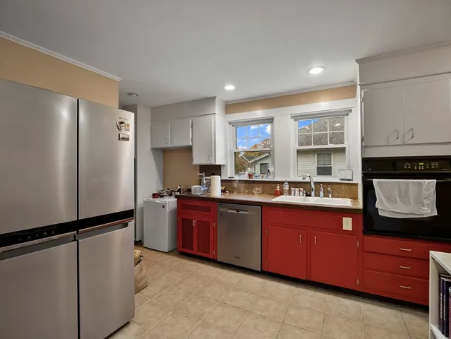 a kitchen with stainless steel appliances granite countertop a refrigerator and a stove top oven