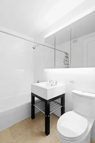 a bathroom with a sink a toilet and bathtub