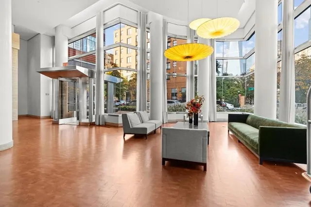 a living room with fireplace furniture and a large window