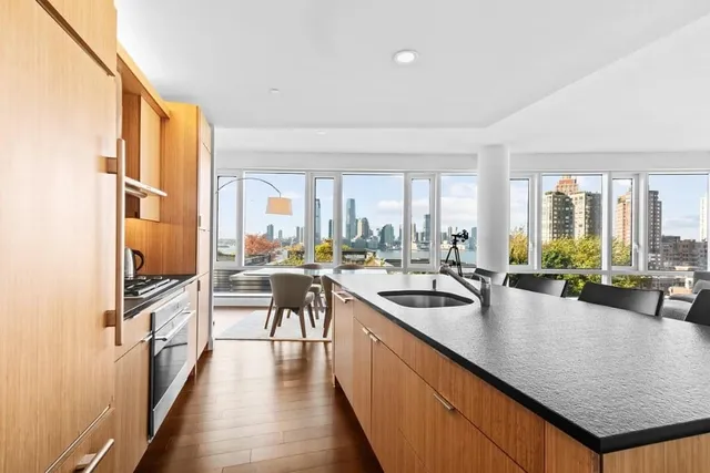 a kitchen with a large window and a counter space
