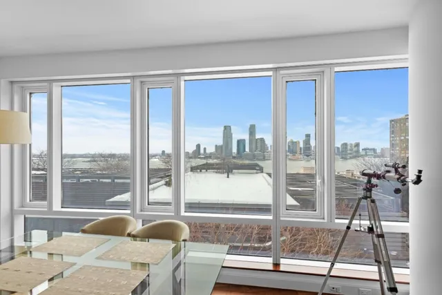 a living room filled with furniture and a floor to ceiling window