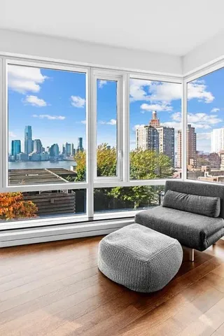 a living room with couch and a large window