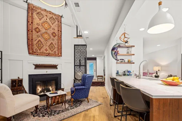 a living room with furniture a air conditioner vent and a rug