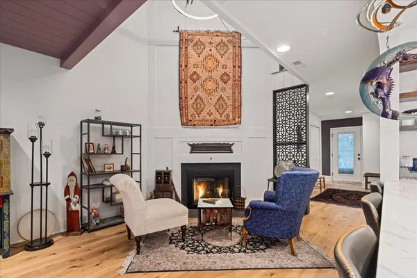 a living room with furniture a rug and a fireplace