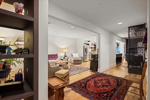 a living room with kitchen island furniture and wooden floor