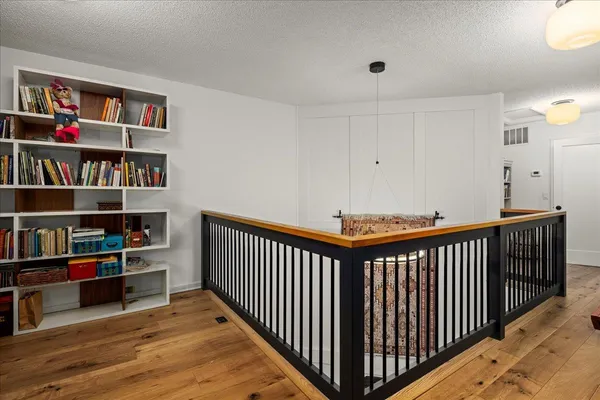 a bedroom with furniture and wooden floor