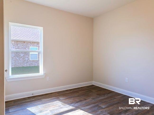 16810 Rocher Court Foley, AL 36535 - Photo 20 of 24 Room featuring wood-finish flooring, neutral wall paint, and white baseboards