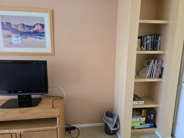a view of a hallway with closet and a fireplace