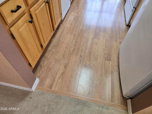 a kitchen with stainless steel appliances granite countertop a sink dishwasher stove and wooden floor