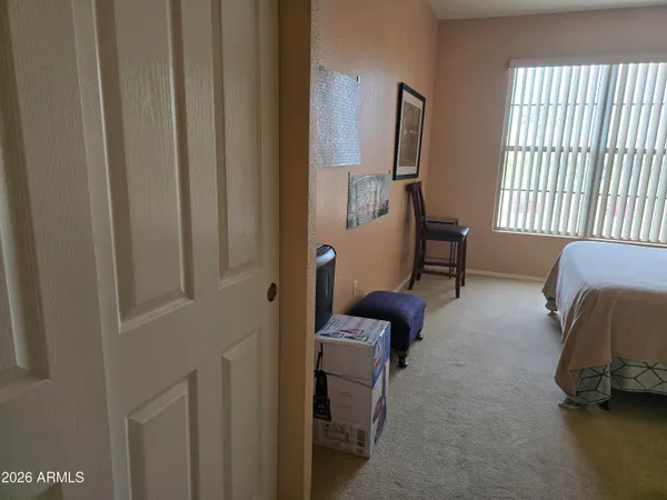 a bedroom with a bed and a flat tv screen