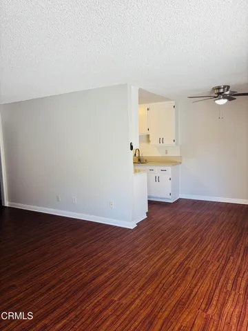 a view of a room with wooden floor and window