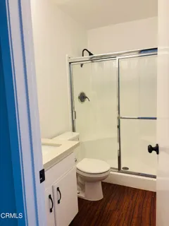 a bathroom with a toilet and a shower