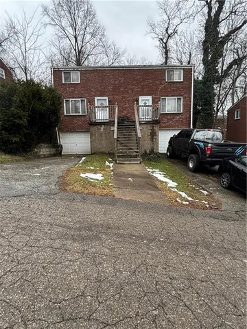 a view of a house with a yard and garage