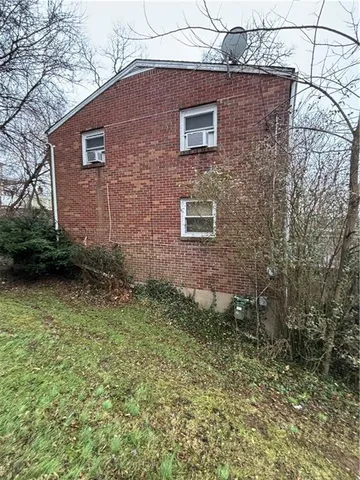 a backyard of a house with barbeque oven