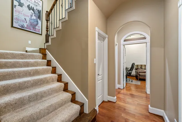a view of entryway and hall with wooden floor