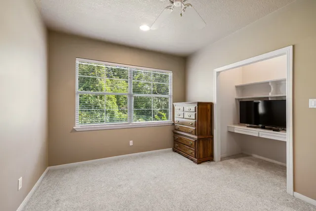 an empty room with furniture and windows