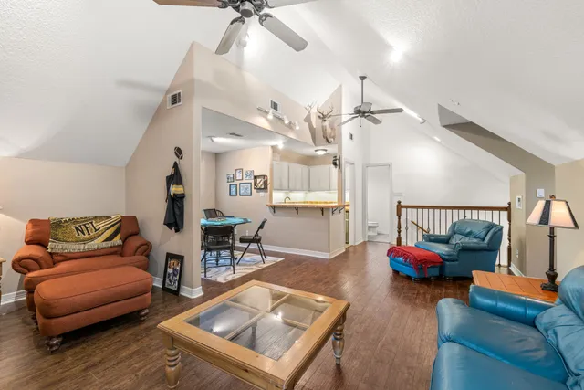 a living room with furniture and wooden floor